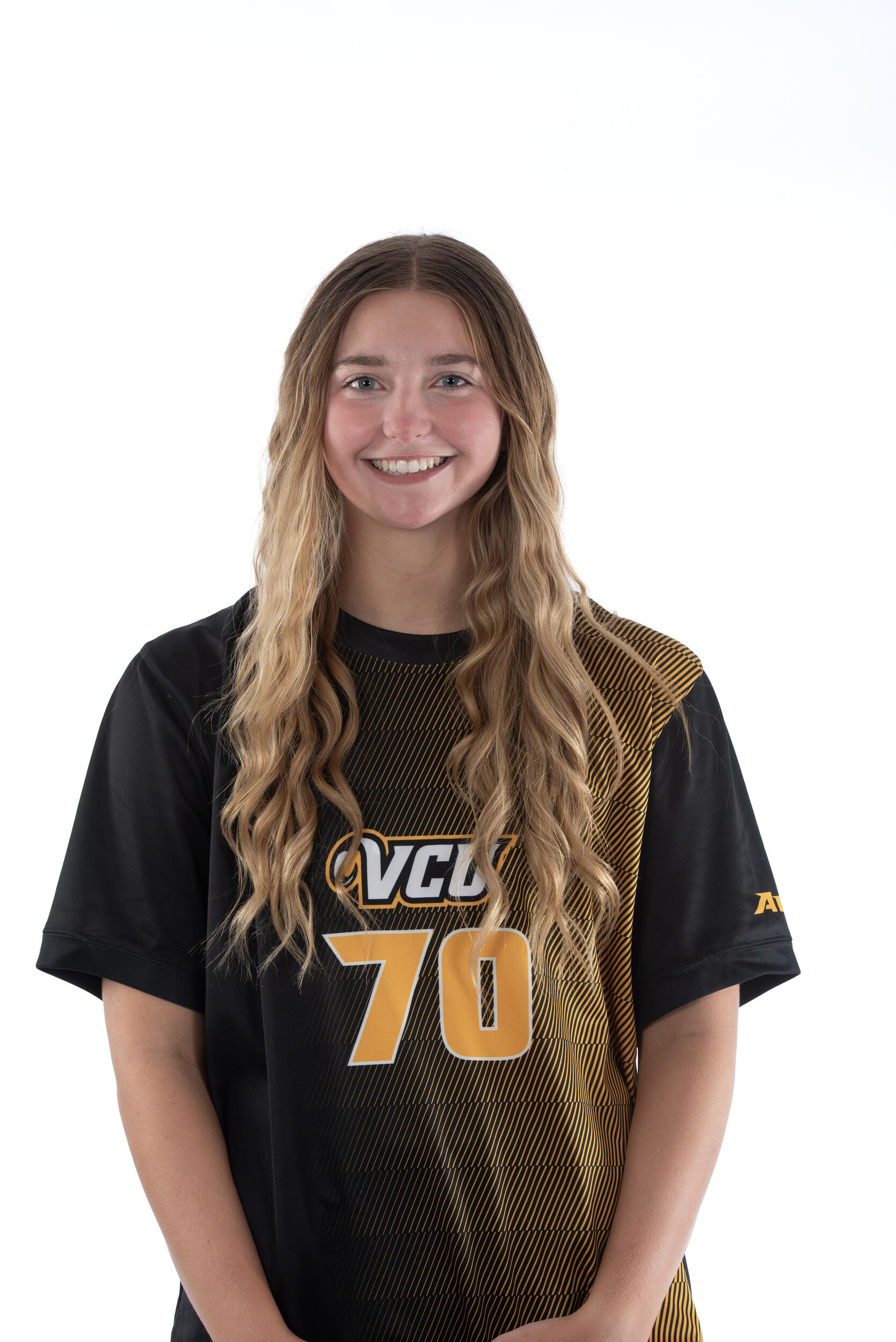 A photo of a woman wearing a sports jersey from the waist up. 