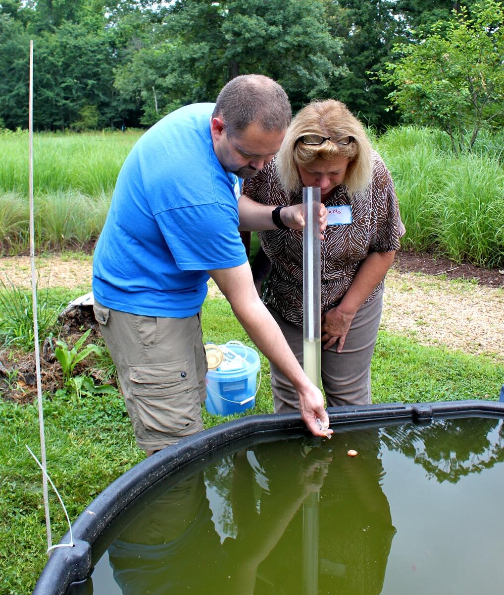 This past summer’s teacher workshop participants measuring water clarity of the sunny mesocosm at the VCU Rice Center using a Secchi Disk. Image Courtesy of Lindsey Koren/VCU.