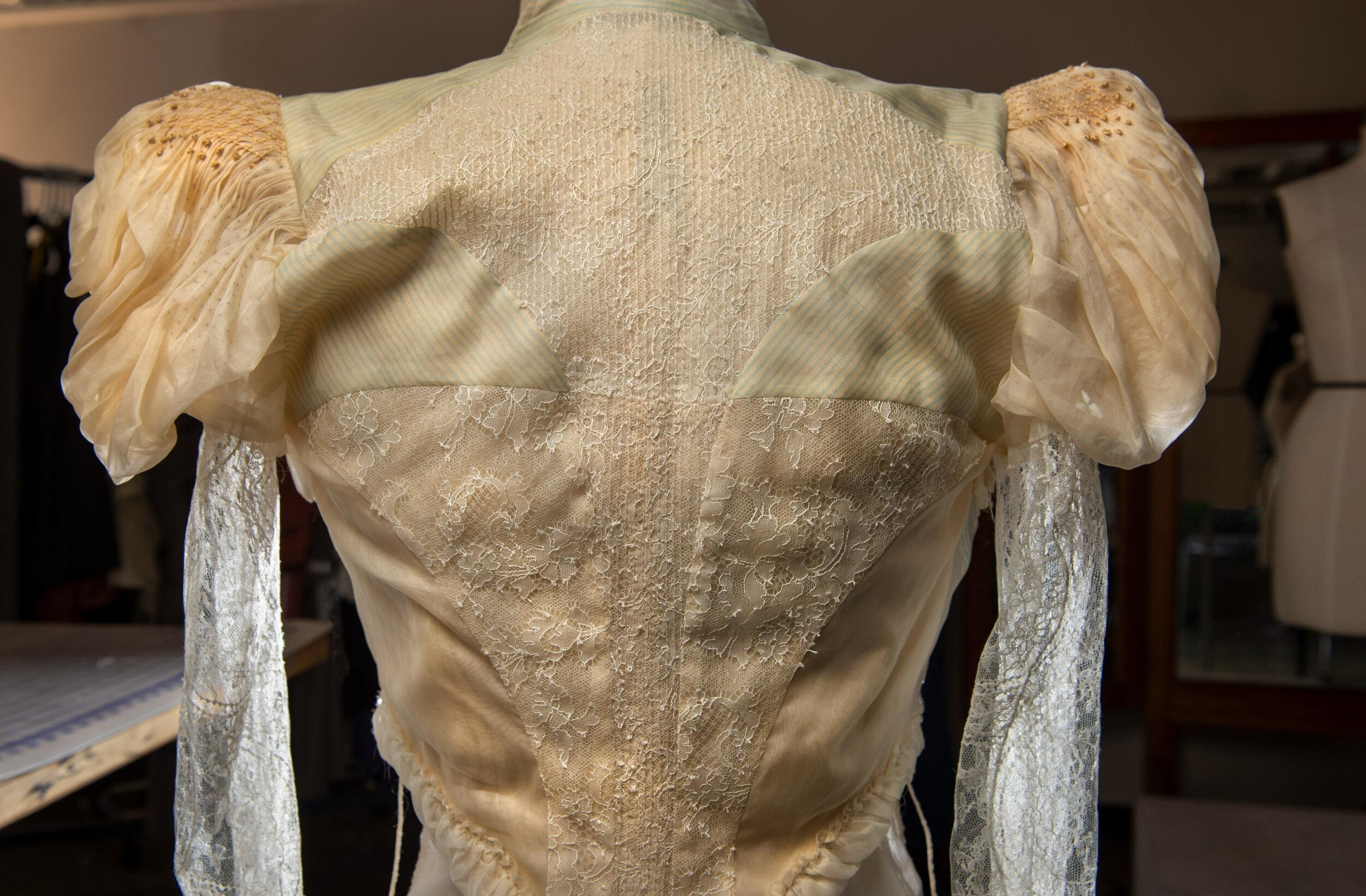 A photo of the back of a vintage cream jacket. 