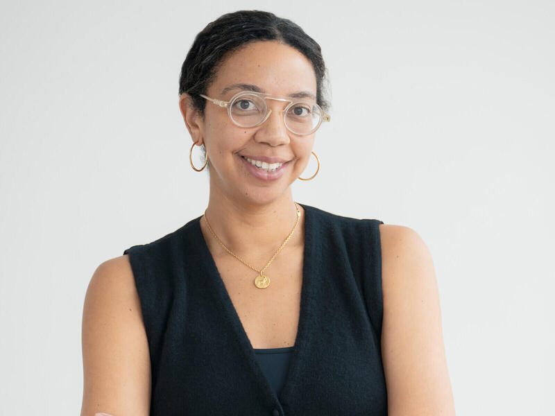 A photo of a woman wearing glasses. 