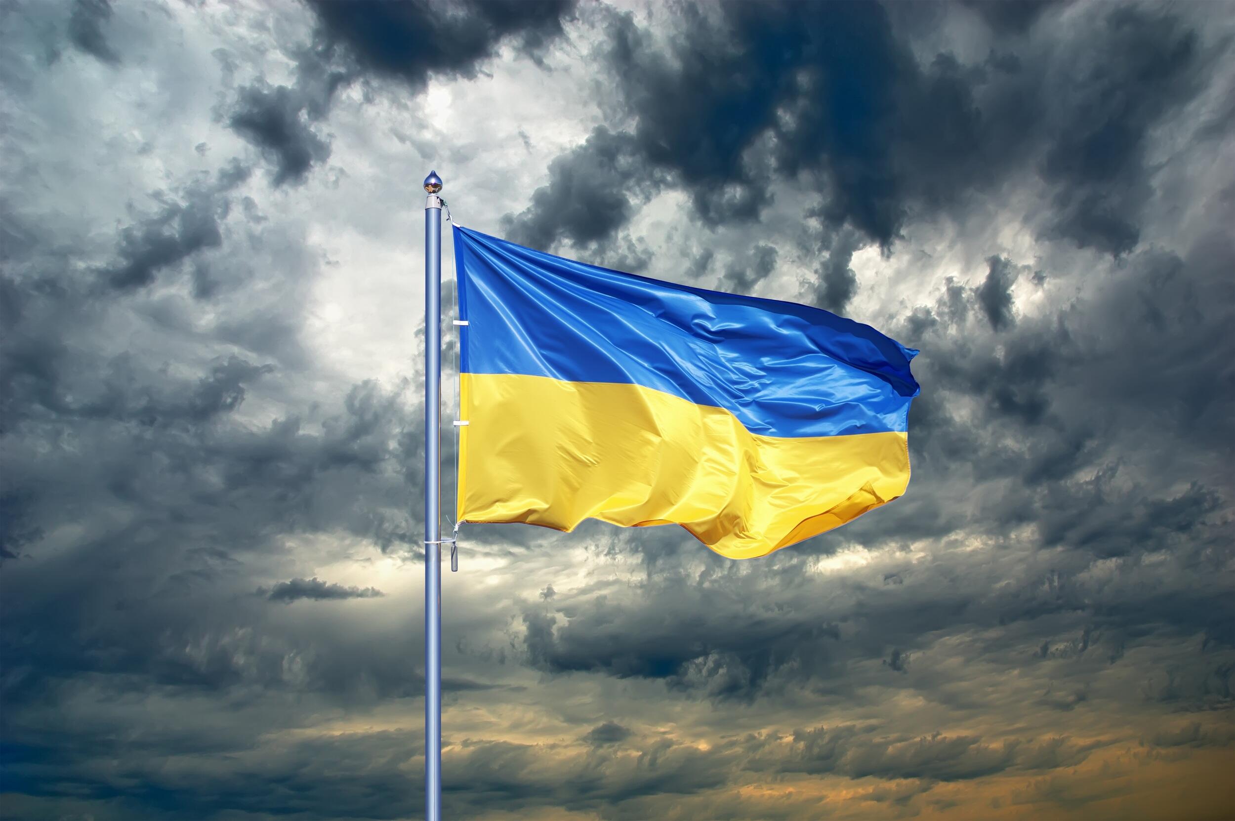 The Ukrainian flag being blown by wind in front of a cloudy sky