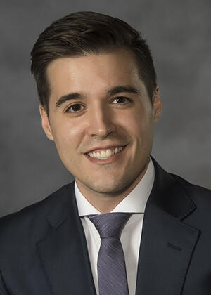 A photo of a man from the shoulders up. 