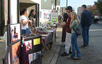 Festival goers look over handicrafts being sold by Ten Thousand Villages, a shop and "alternative trading organization" from Richmond's Carytown neighborhood that donates proceeds to people in Third World countries.