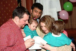 From left: Keith, Caroline, Tiffany and Madeline Berkle eagerly open Keith's envelope while another student looks on.