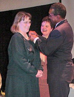Melinda E. Batalias (left), who teaches math at Lloyd C. Bird High School in Chesterfield County, was one of 38 teachers in the Richmond area to achieve National Board Certification this year. At a VCU ceremony, she received a pin recognizing her achievement from Chesterfield County Public Schools Superintendent Billy K. Cannaday (right). State Superintendent of Public Instruction Jo Lynne DeMary (center) looks on.

Photo by Tomaree Porter, VCU School of Education