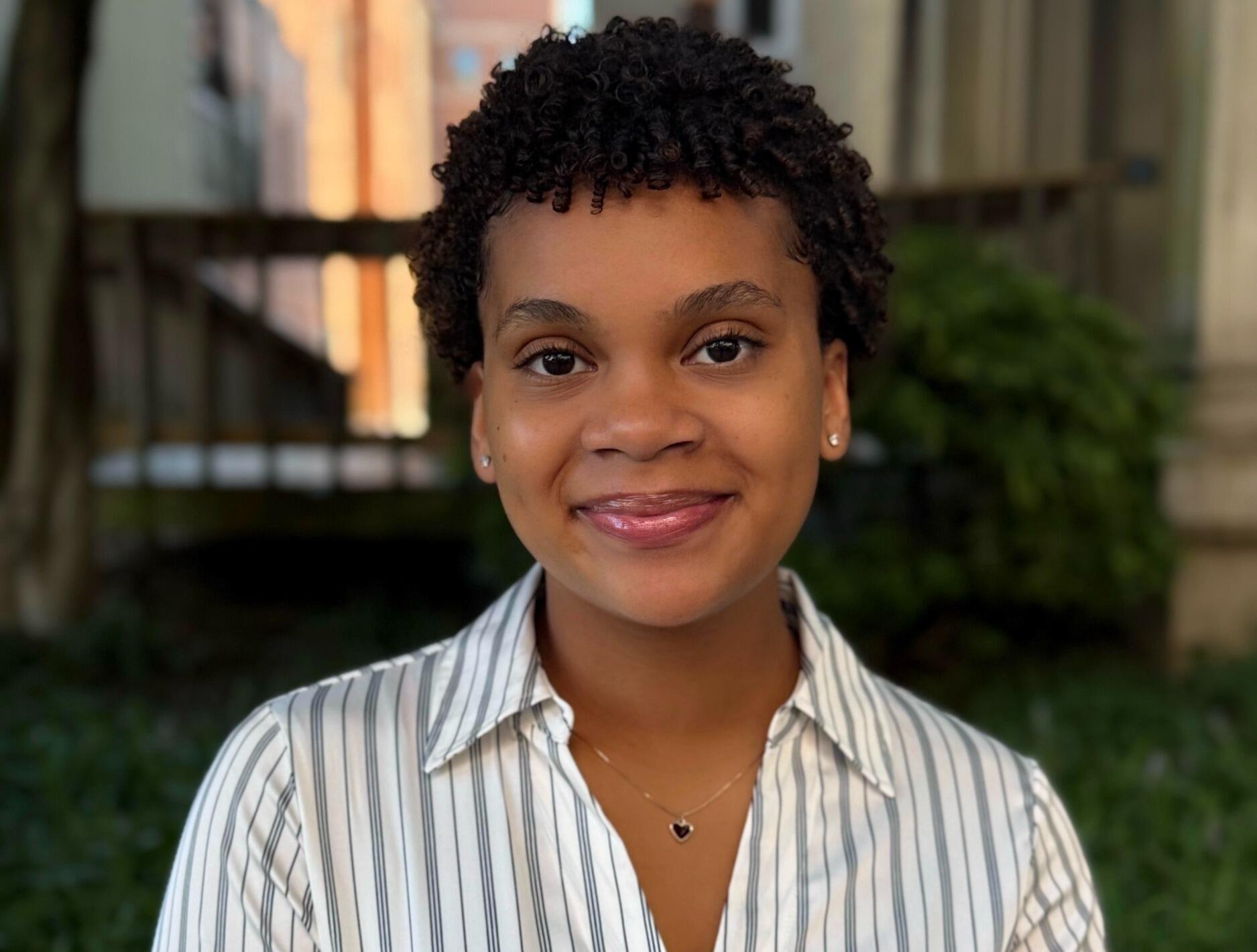 A photo of a woman from the shoulders up. 