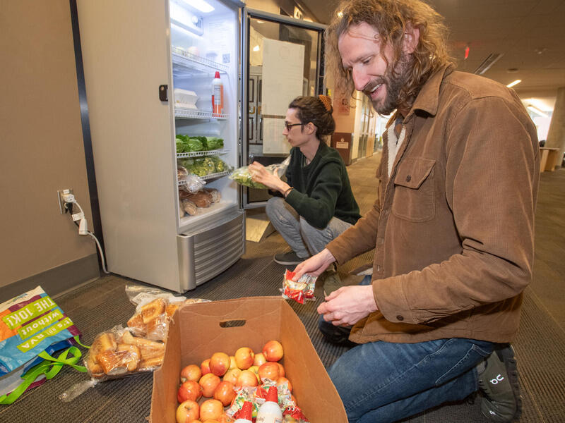 John Jones, Ph.D., and Federal Work-Study students like Jade Underwood make sure that the campus' three Ram Fridges are stocked and monitored for safety. (Thomas Kojcsich, Enterprise Marketing and Communications)