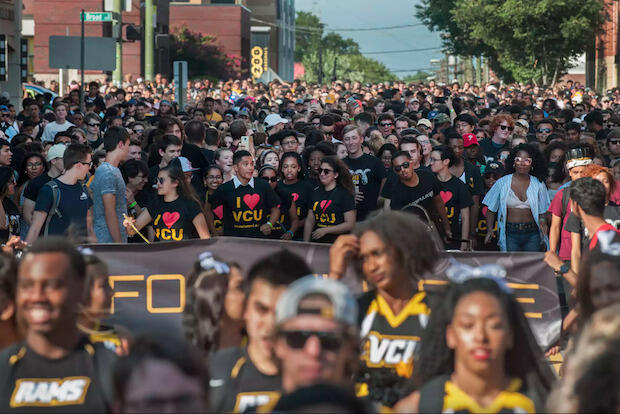 New VCU students, in a large crowd of black and gold, parade down Harrison St. from the Siegel Center to the University Student Commons at the annual Ram Spirit Walk. (File photo)