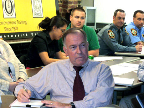 Associate Professor William Parrish (center) played the role of the governor in the exercise and received an update on decisions made by the 20 student participants in responding to the “crisis.” Modeling and simulation software by L-3 Communications Services Group, a communications and surveillance products and services company, helped the students manage regional emergency response assets as they established police road blocks, coordinated evacuations and directed fire and EMS response.  