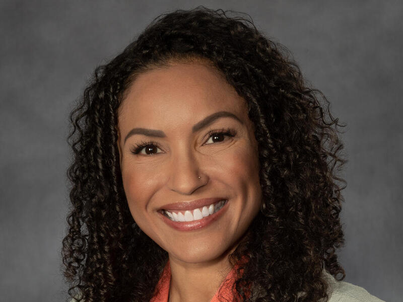 A photo of a woman from the shoulders up. 