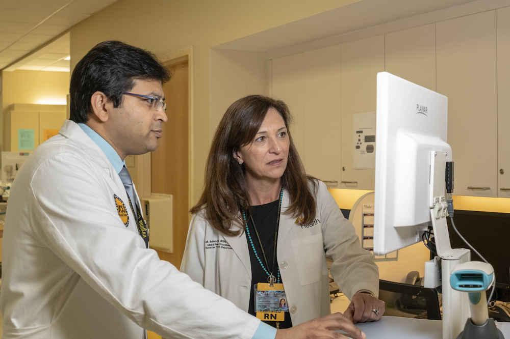 Gaurav Gupta, M.D., and Merv Baldecchi of VCU Health's Hume-Lee Transplant Center explore kidney transplants from HIV-positive donors to HIV-positive patients. (Photo by Joe Morris, Department of Surgery)