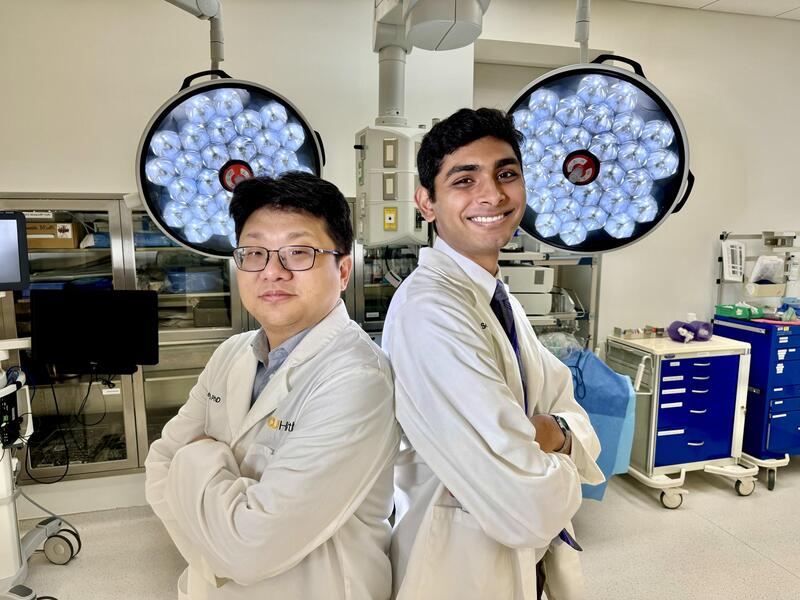 Seung Duk Lee, M.D., Ph.D., a VCU Health Hume-Lee robotics surgeon, stands in a medical space with Kush Savsani, a research assistant and incoming student at the VCU School of Medicine. (Photo by Jeff Kelley)