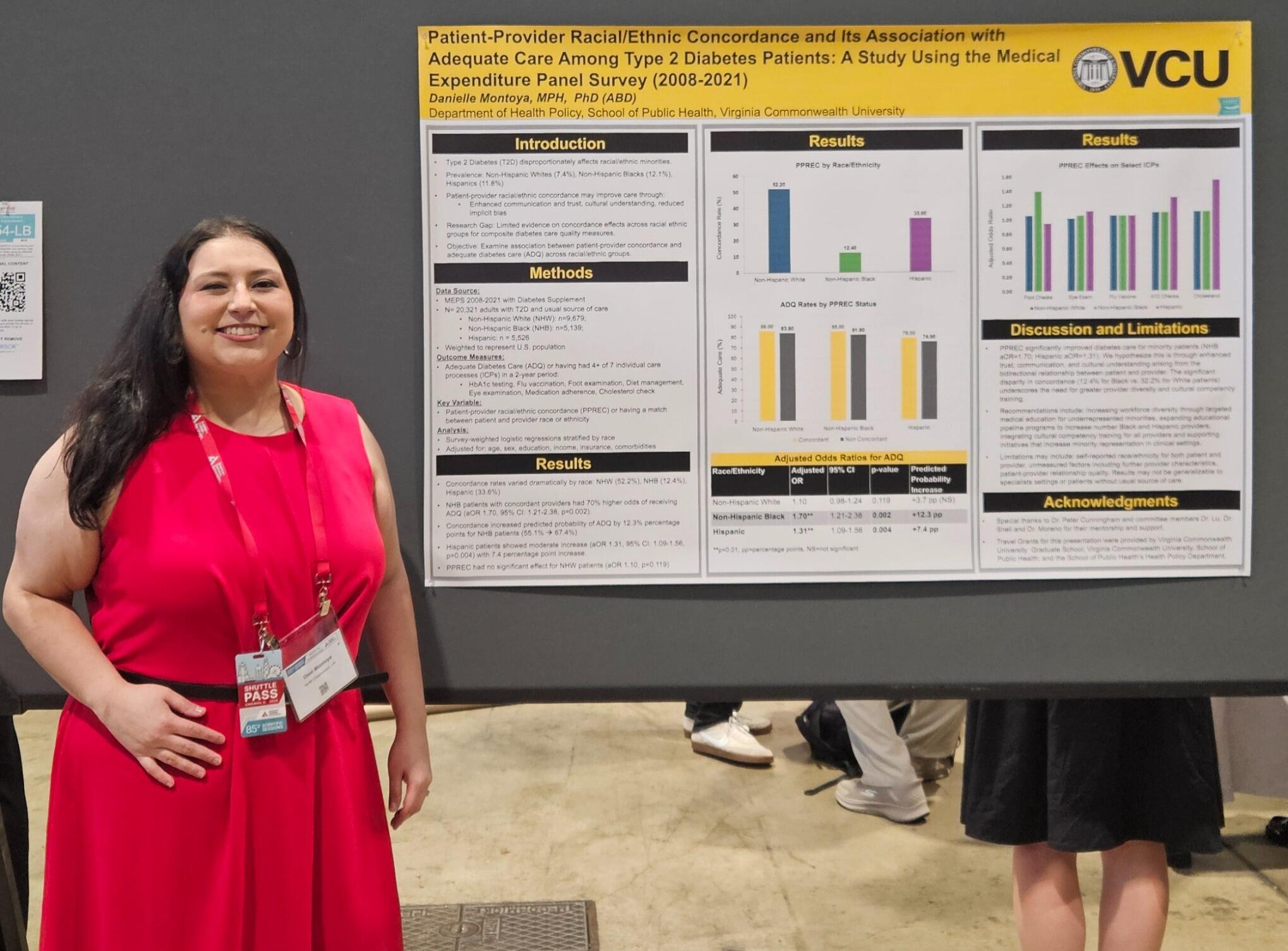 A photo of a woman standing to the left of a research poster. 