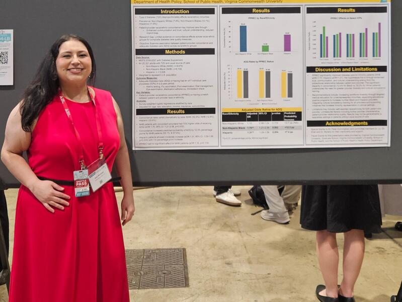 A photo of a woman standing to the left of a research poster. 
