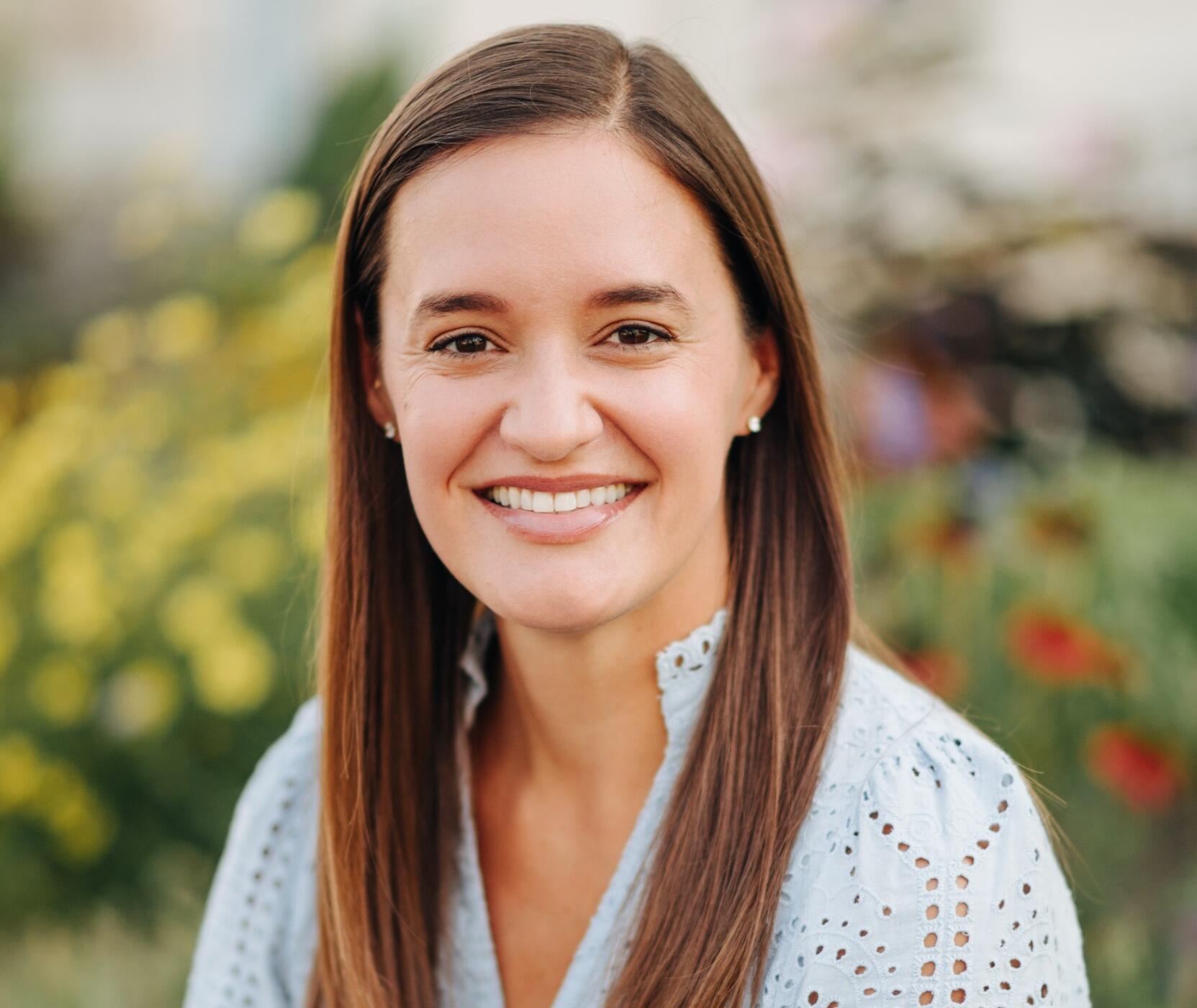 A photo of a woman from the shoulders up. 
