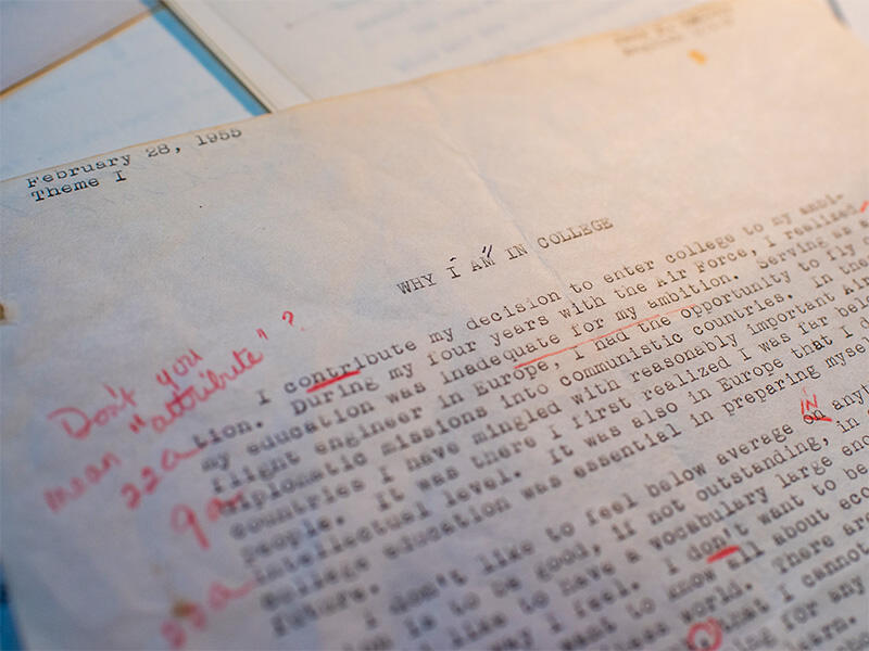 A photo of an essay with red annotaion notes on it. 