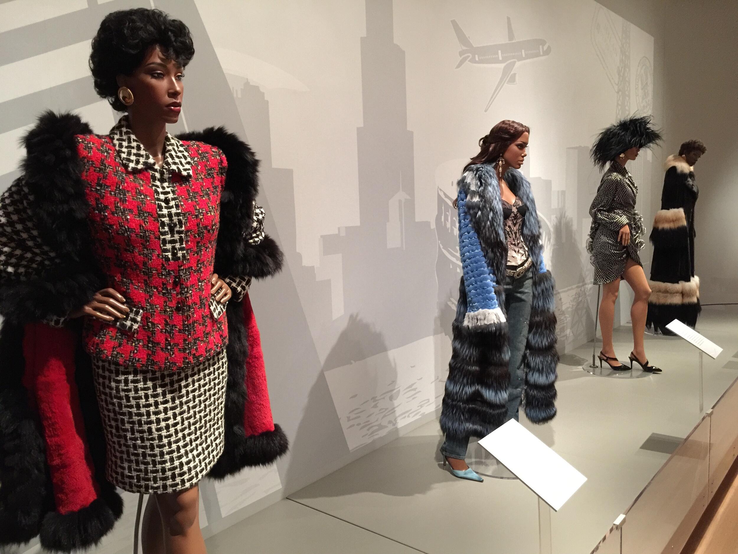 Four mannequins wearing fashion from the 1980s through 2000s. 