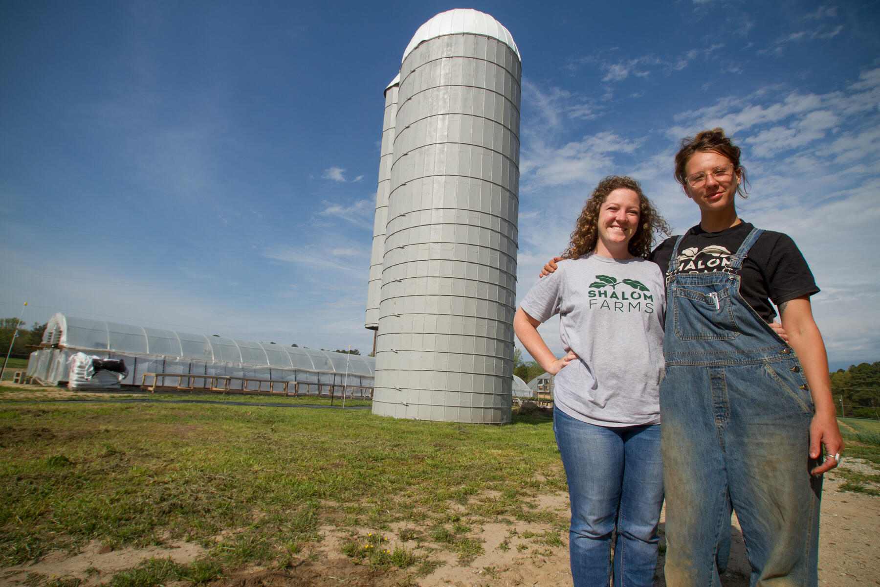 Adams (left) and Burke by Shalom Farms' silo.