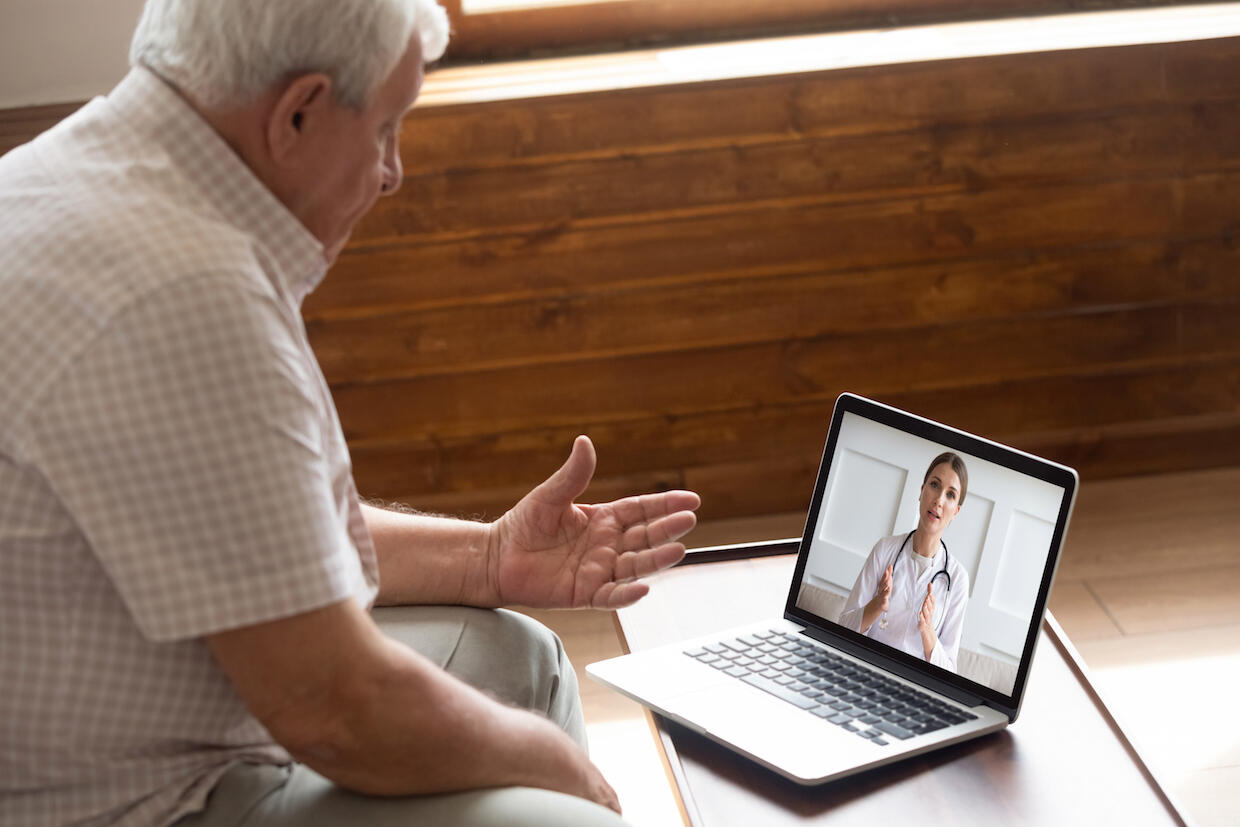 A doctor speaks to a patient via videoconference.