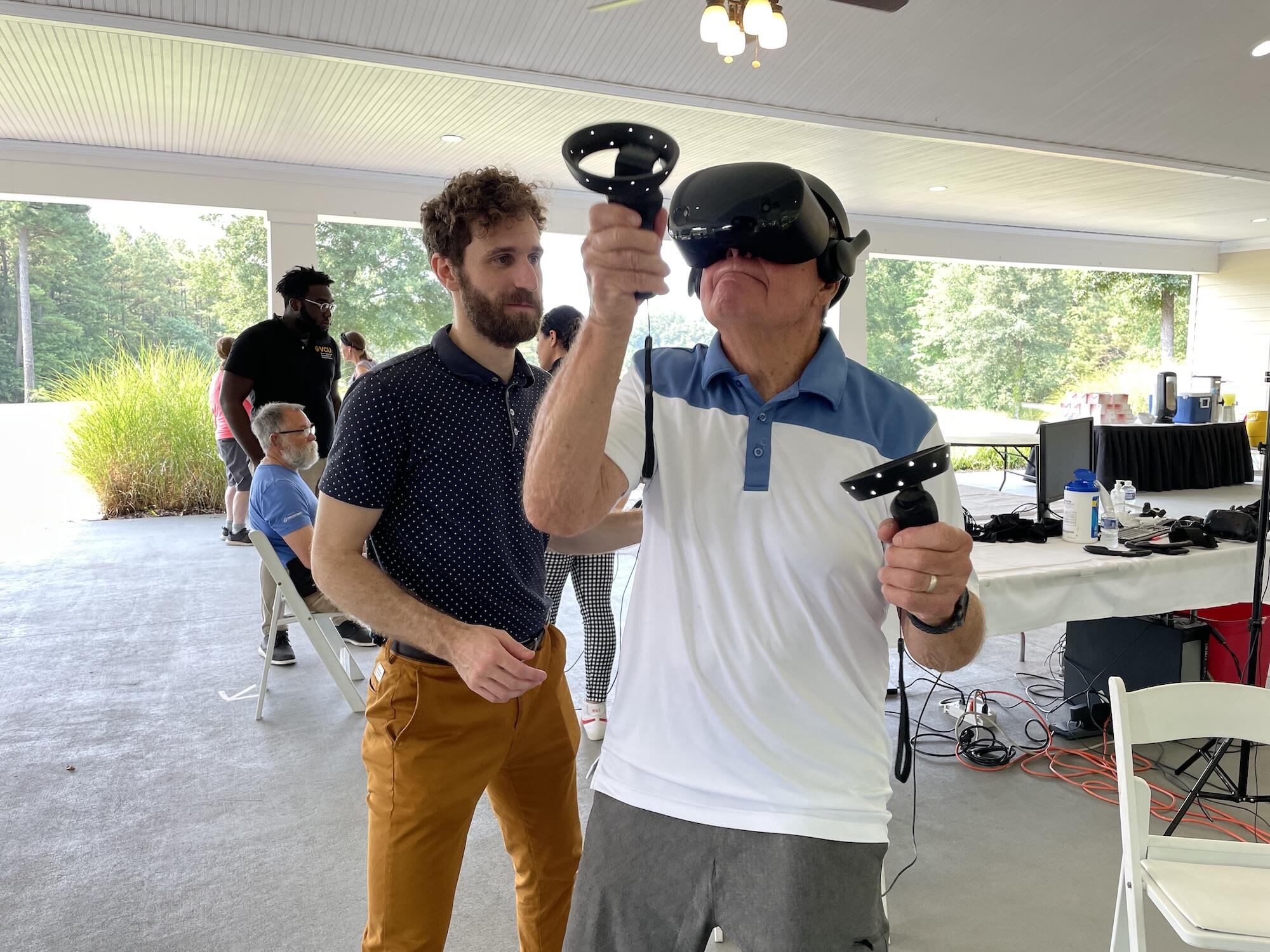 Alexander Stamenkovic and Bill McDaniel, trying out a dodgeball game using a VR headset.