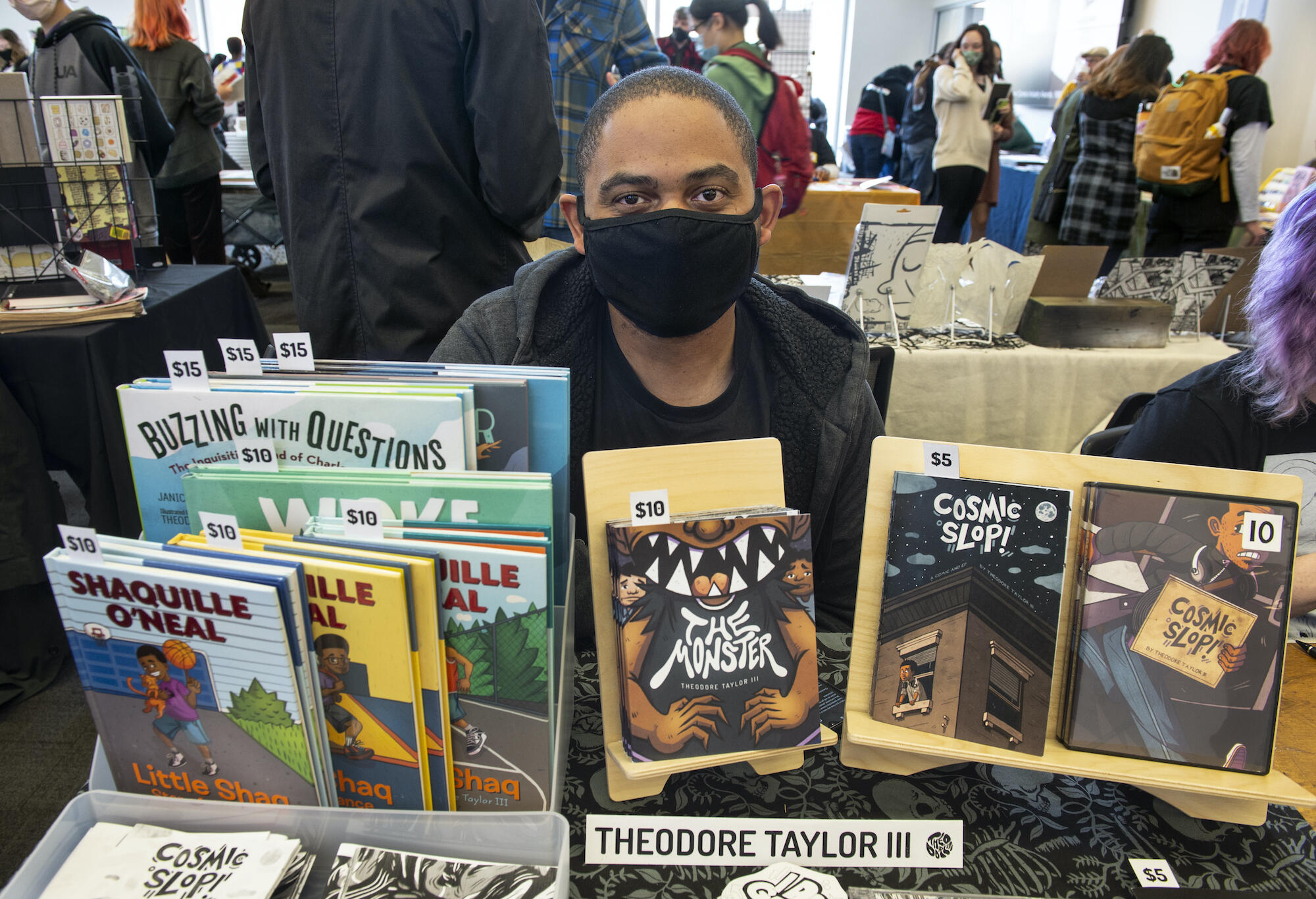 Theodore Taylor III, a 2008 VCU graduate, with books he has illustrated for authors.