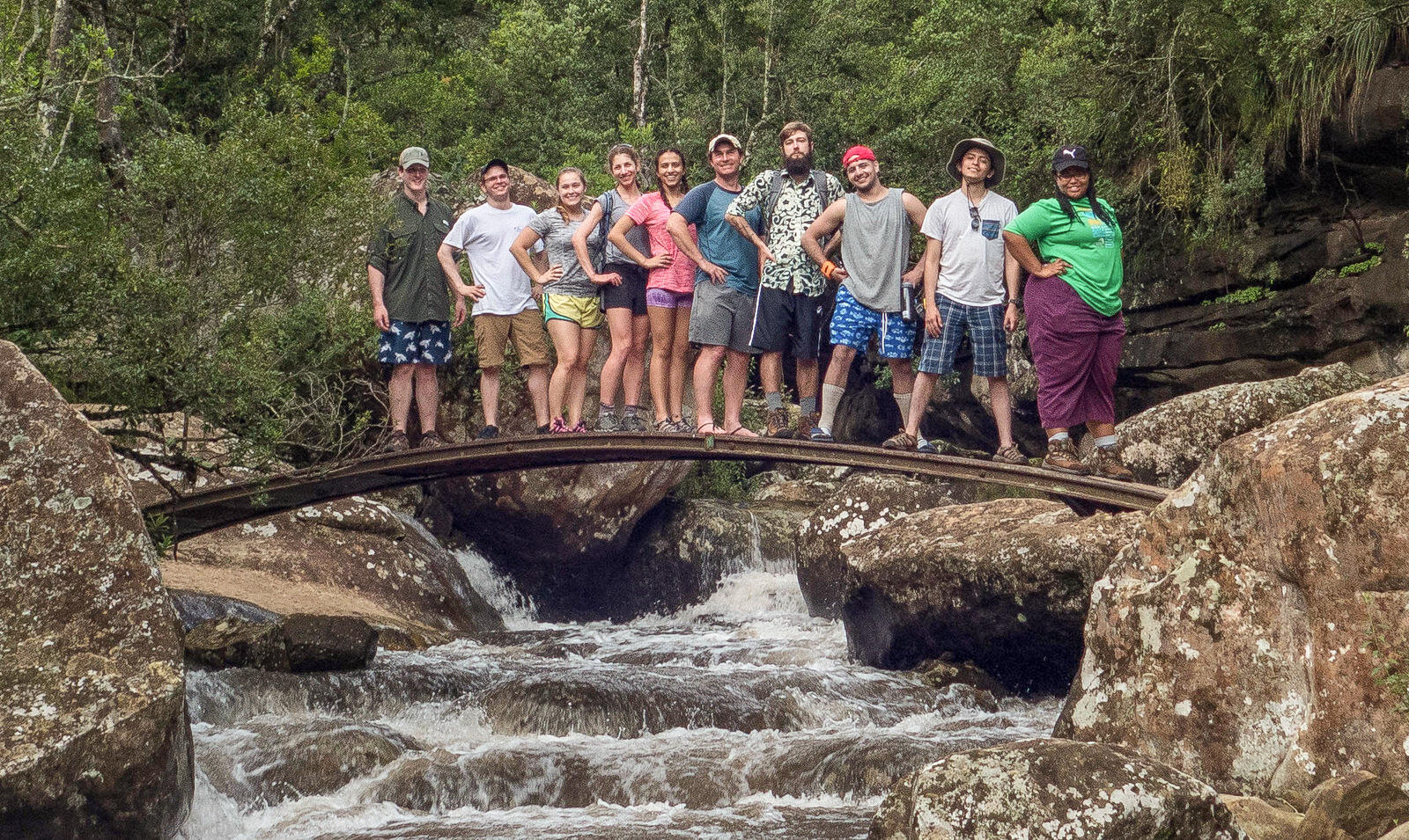 Group photo on footbridge over Mahai River in Royal Natal National Park. Pictured from left to right: Thomas Vinyard III, Nick Kelly, Christine Savoie, Shira Lanyi, Simren Bhatt, James Vonesh, Trevor Young, Mahad Mustafa, Diego Azuga and Nycole Taliaferro. Not pictured: Dan Carr.
<br>Photo by Dan Carr.