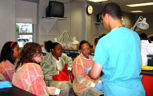 Graduate student Brian Dunn shows high school students how to dissect a pig’s foot.
Photo by Brooklyn Jones, University News Services