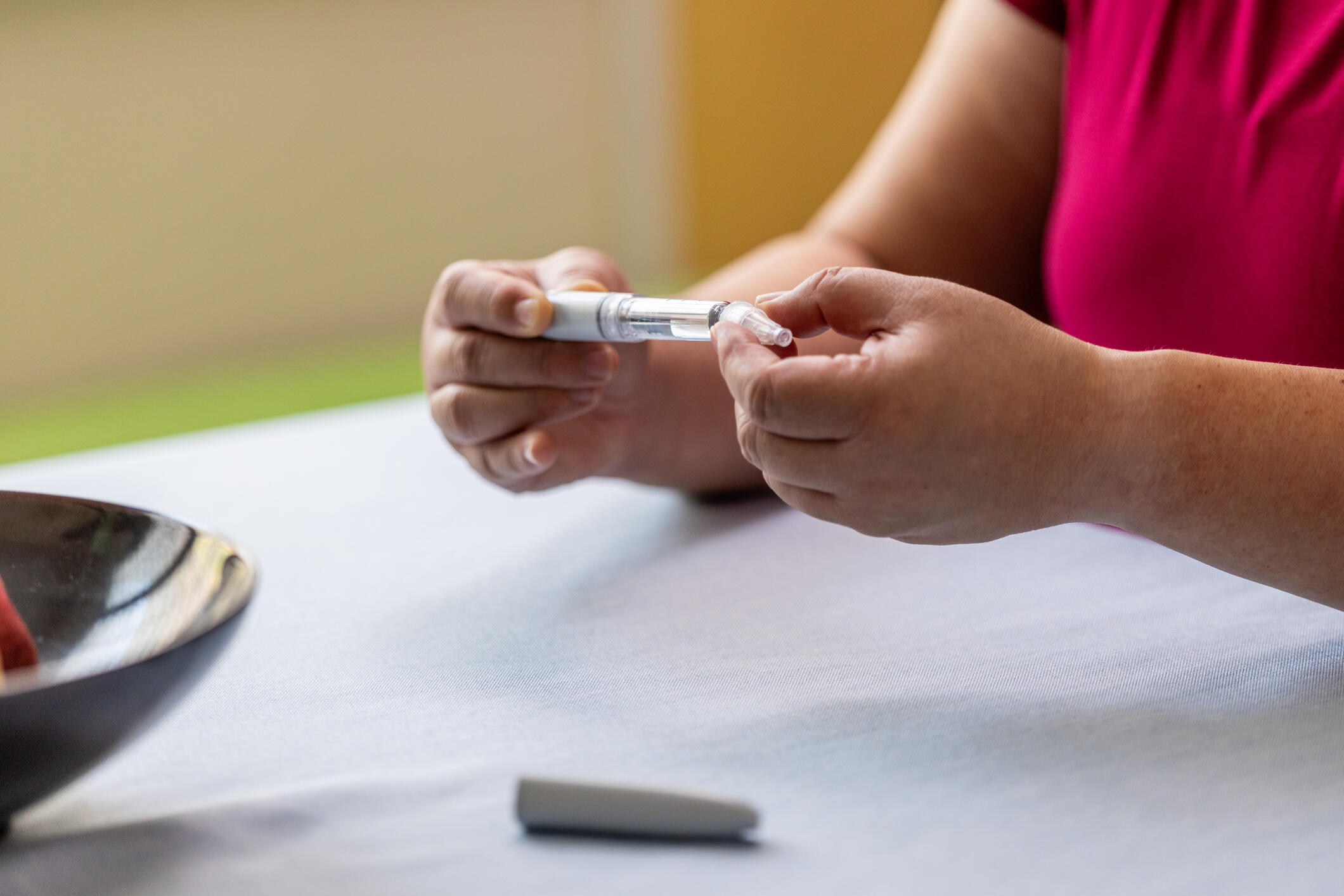 A person holds a GLP-1 injection device.