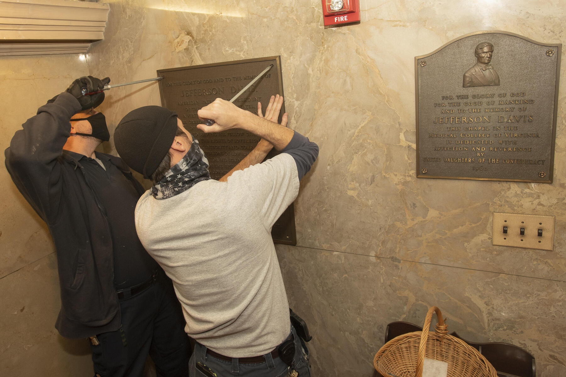Plaques are removed from the Jefferson Davis Memorial Chapel in the West Hospital. (Tom Kojcsich, University Marketing)