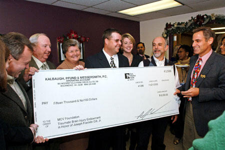 Brooke Anne Hunter (from right), Jeff’s attorney; Chip Kalbaugh, Jeff’s attorney; Frank Gill, Jeff’s father; Barbara Gill, Jeff’s mother; J.F “Jeff” Gill Jr., former traumatic brain injury patient; Marie Walker, Jeff’s sister; Jeffrey S. Kreutzer, Ph.D., professor and vice chair of PMR research division; and David Cifu, M.D., PMR chair; gather for the check presentation to the department’s traumatic brain injury endowment fund. 

Photo by Jennifer Watson, VCU Creative Services