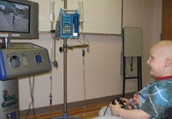 Thomas Nicholson, a four-year-old patient at the VCU Medical Center, enjoys the crystal-clear graphics from the flat panel monitor while trying out a skate boarding game on the new Fun Center's Nintendo Game Cube.