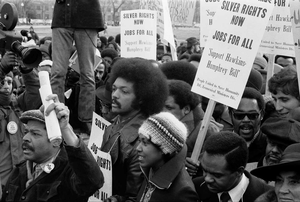 Jesse Jackson surrounded by marchers in Washington, D.C., in 1975, advocating support for the Hawkins-Humphrey Bill for full employment.