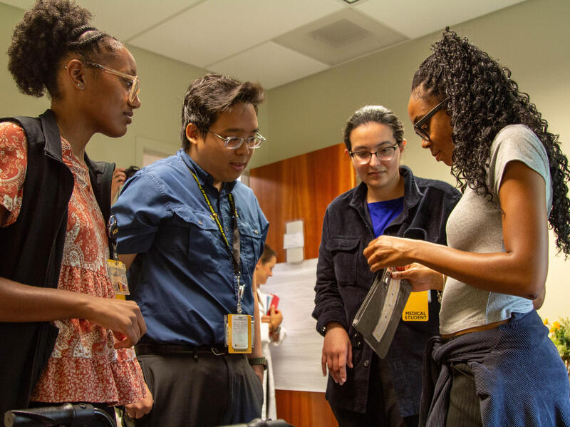 A photo of four people talking. 