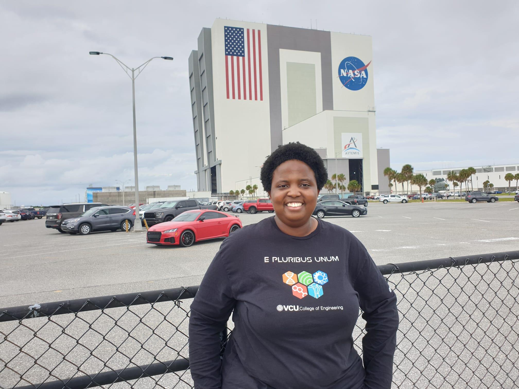 A woman standing in front of a NASA building