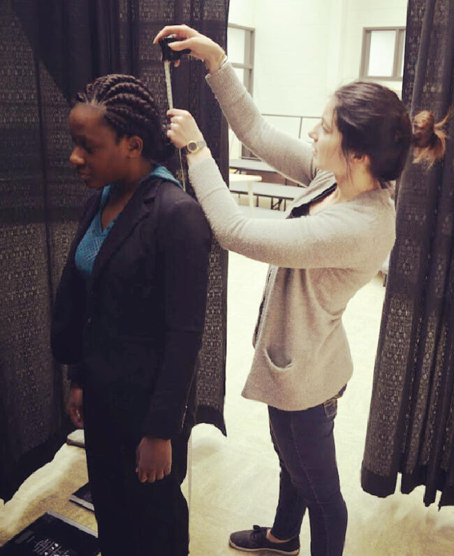 Third-year pharmacy student Jessica Roller measures Lucy Bonney's height in order to calculate her body mass index. Bonney attended the fair to have various health screenings done, including BMI, glucose and cholesterol checks.