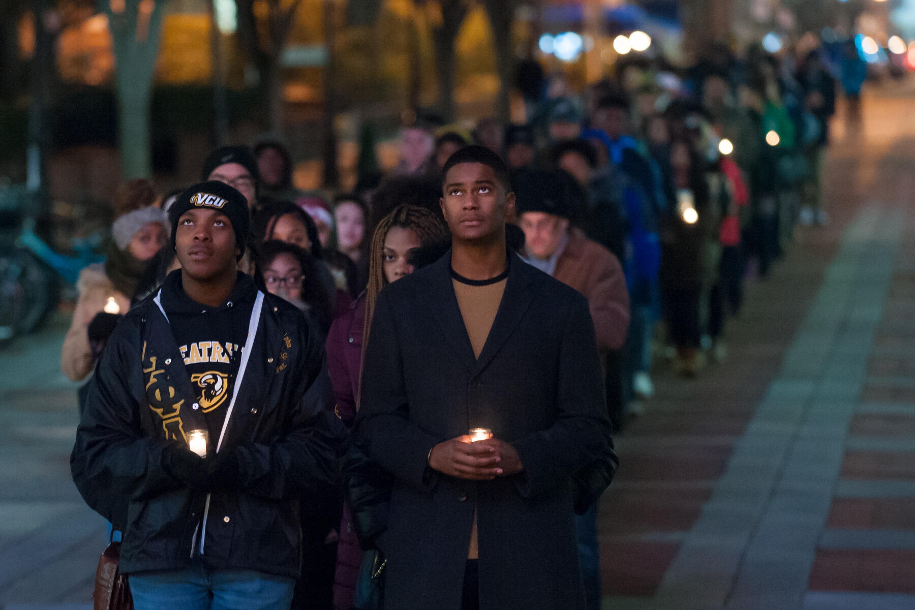 Students stop at Cabell Library last year during the candlelight vigil for Martin Luther King Jr. (Photo by Kevin Morley, University Marketing)

