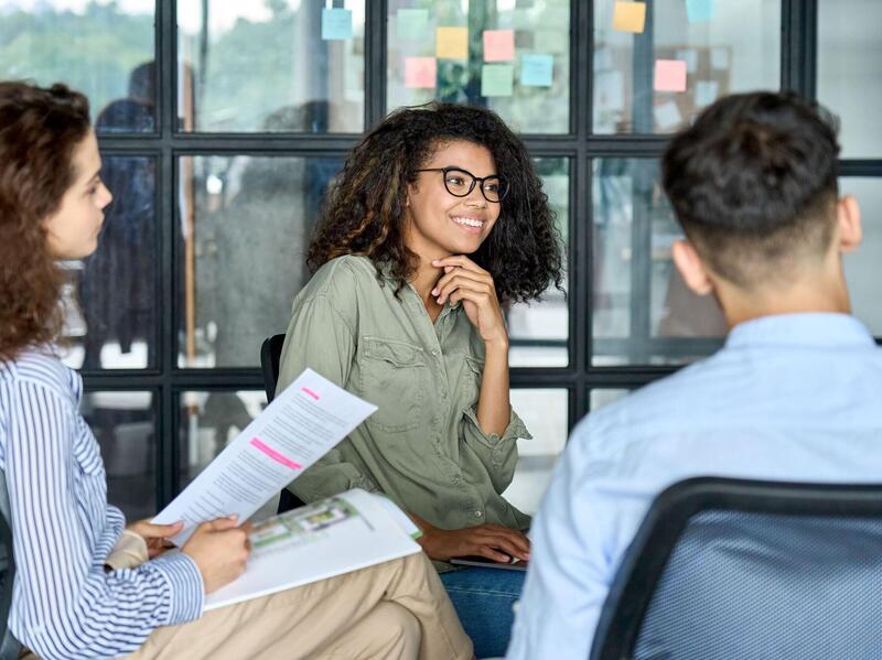 Three people sitting in chairs 