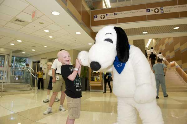 Snoopy plays with patient Cameron Hershey. Photos by Tom Kojcsich, VCU University Relations