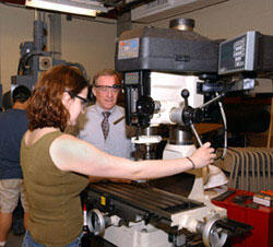 Alonso, who also is a member of the VCU Mechanical Engineering Industrial Advisory Board, observes mechanical engineering student Leah Lovell operate a drill press.

Photos by Jennifer Watson, Creative Services