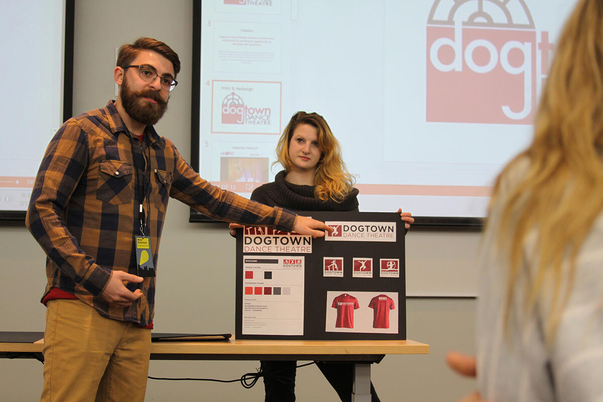 Mike Rodriguez, a junior creative advertising major, and Caity O'Connor, a senior creative and strategic advertising major, present marketing materials they created for Dogtown Dance Theatre during CreateAthon. 