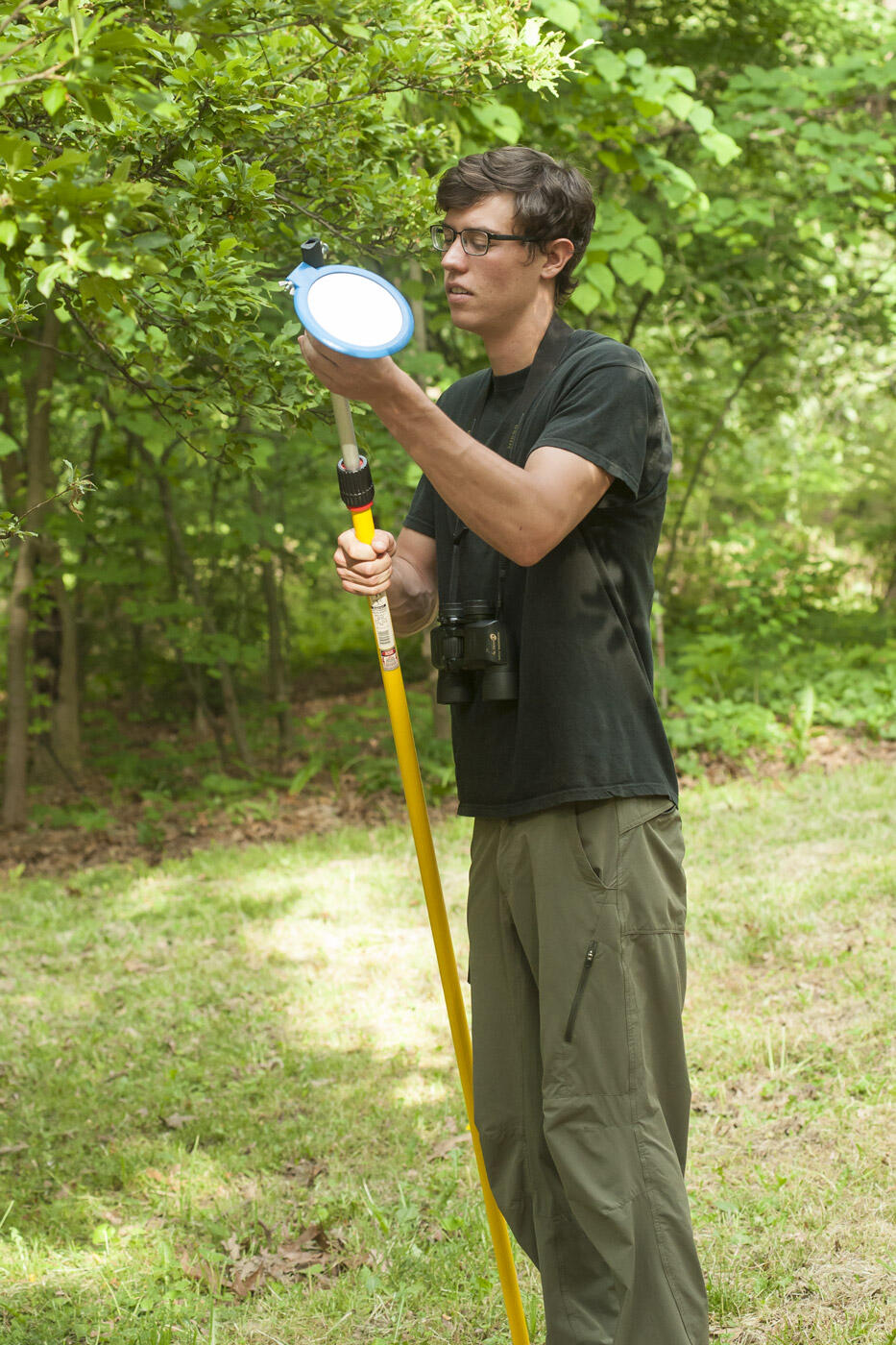 Dan Finnell, a senior environmental studies major, prepares to use an extendable mirror, which the team sometimes uses to check out out-of-reach nests.
