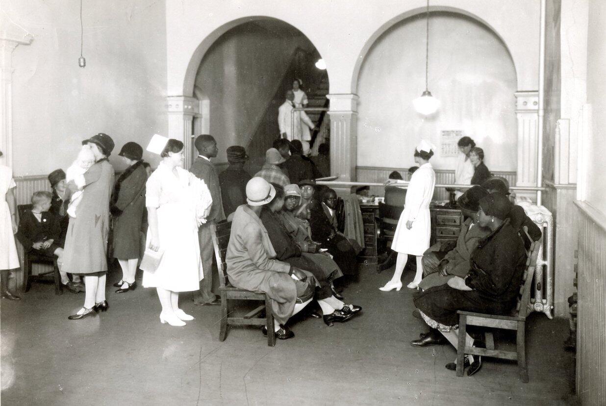 An archival image shows white patients on one side of the outpatient waiting room in the old Virginia Hospital at the Medical College of Virginia and African American patients on the other