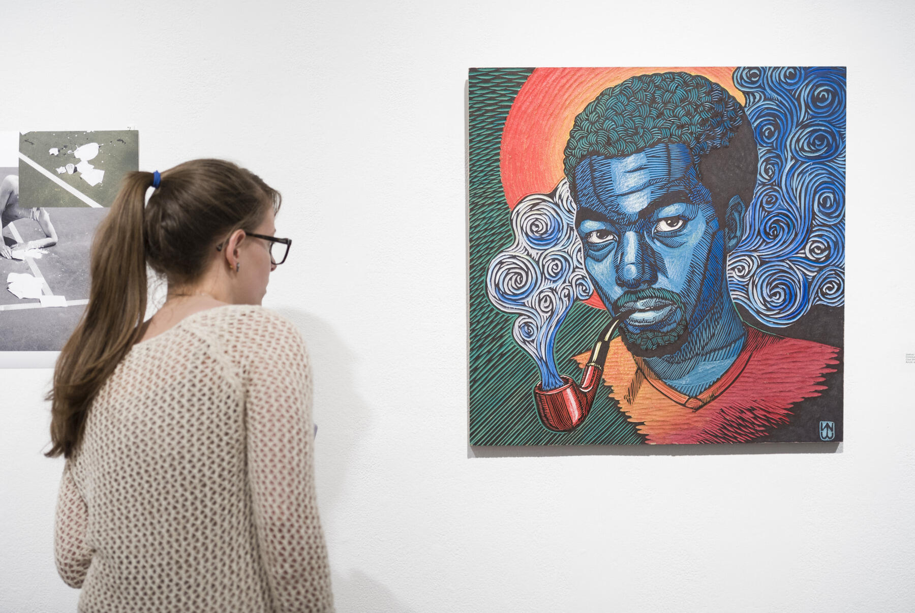 A student views artwork at the 2015 Juried Fine Arts, Design & Kinetic Imaging Exhibition at the Anderson Gallery. (File photo)