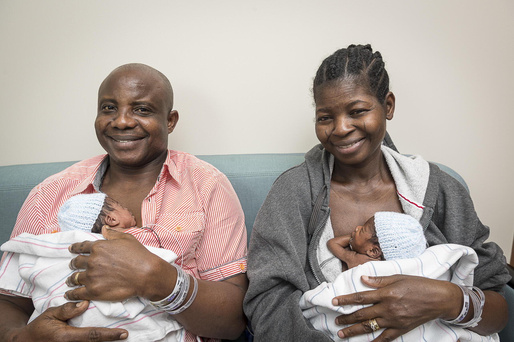 (L to R) Adeboye and Ajibola Taiwo held two of their sextuplets on May 23, 2017. The couple practiced kangaroo care, also known as skin-to-skin. During kangaroo care, the baby is held against the bare chest of a parent. The act of placing the infant skin-to-skin with mom or dad has been shown to maintain skin temperature regulation of the newborn, increase initiation of successful breastfeeding, and ease the transition to life outside the womb.