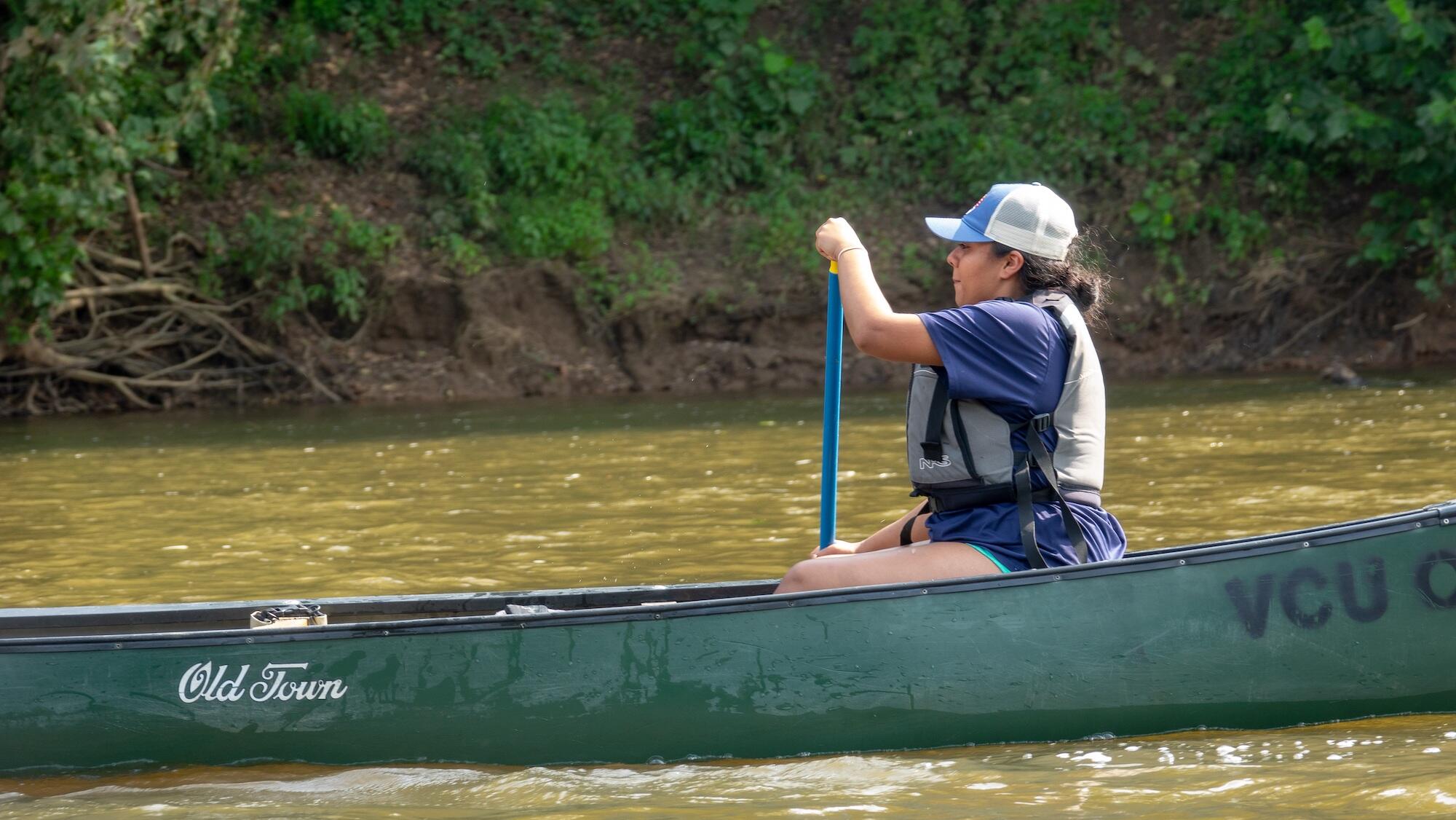 Leonor Rodriguez Guevara paddles a canoe on the James River