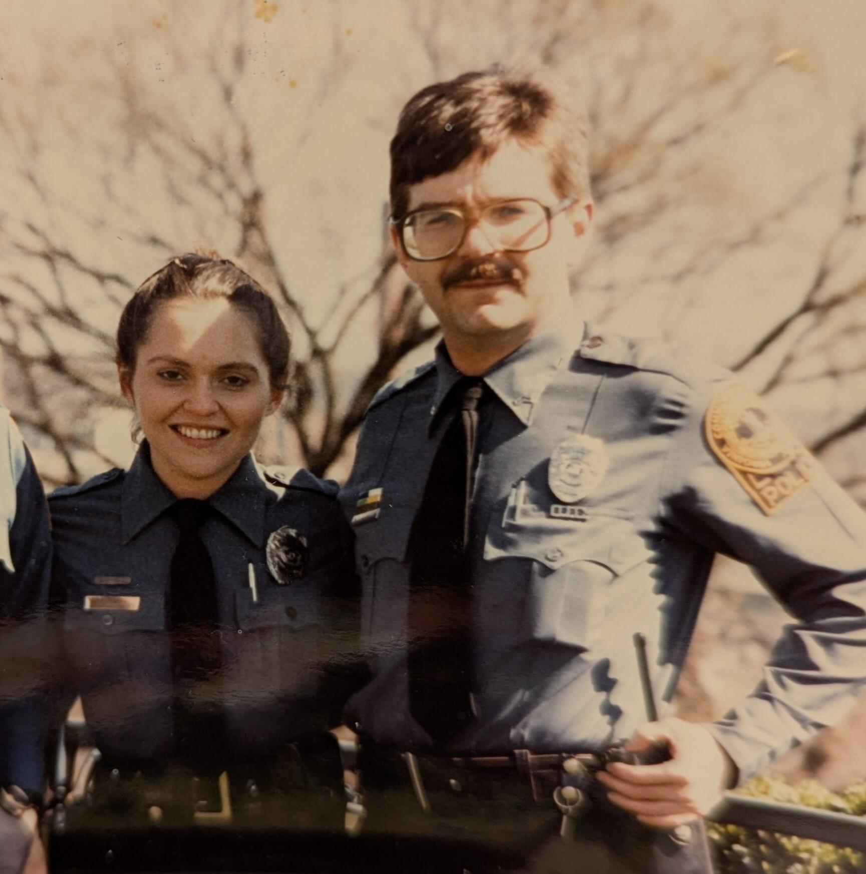 A woman and man in police uniforms.