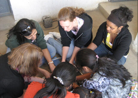 The VCU group also met with women in the village. In this photo, April Shorter offers a papermaking demonstration. The group spent a week in Guatemala in March. Photo provided by Jan Johnston, adjunct instructor, Art Education Department.
  


