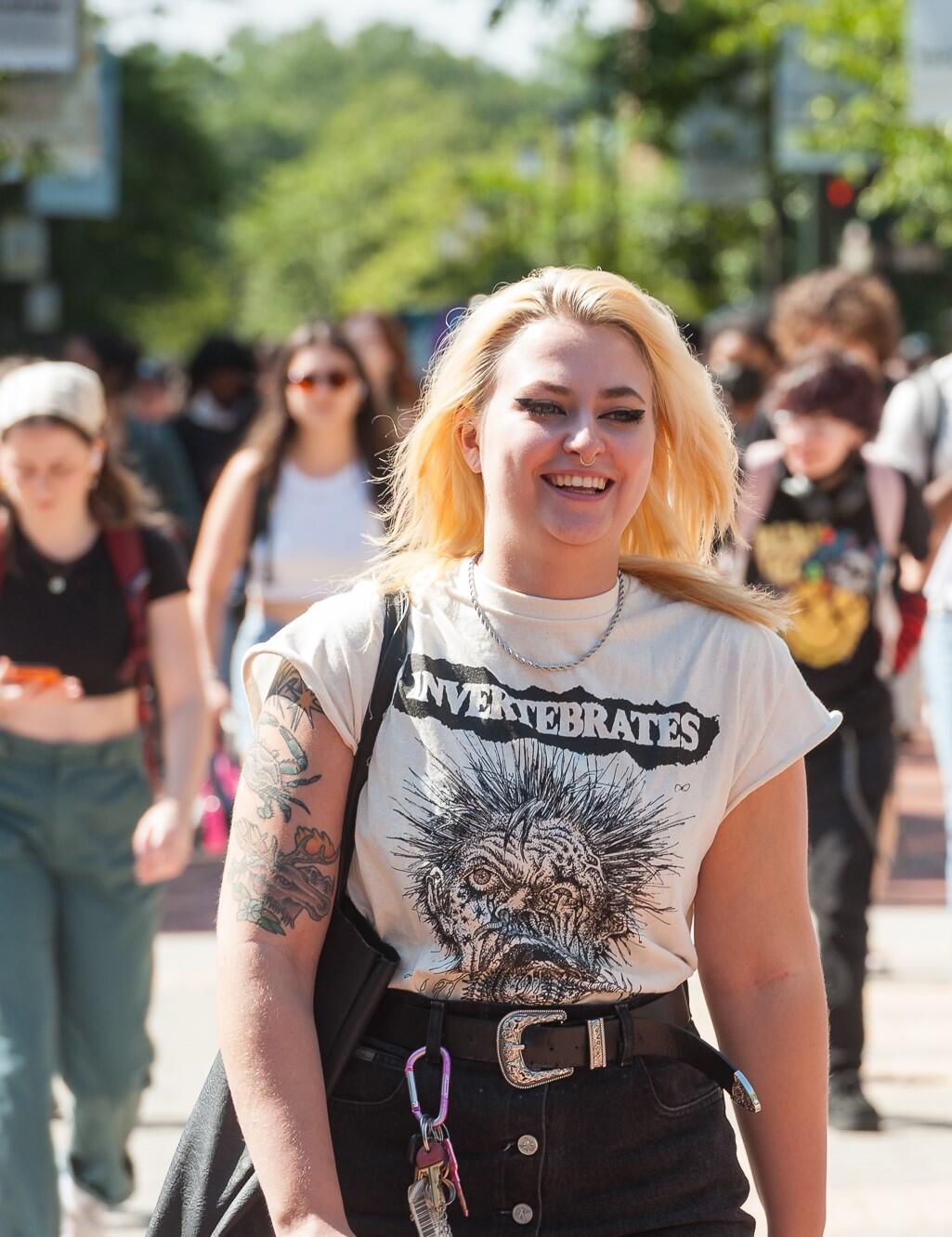 A woman smiling and walking 
