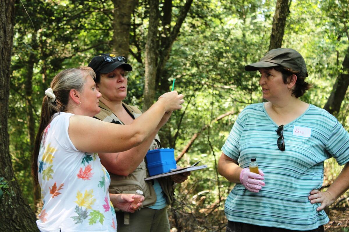 Last summer's teacher workshop participants about to start the titration on measuring dissolved oxygen from the forested mesocosm. Image Courtesy of Lindsey Koren/VCU. 