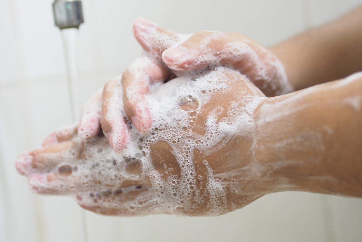 Person washing hands.
